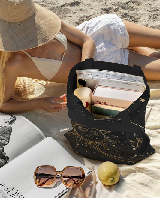 Celestial tote bag open and filled with books and essentials at the beach