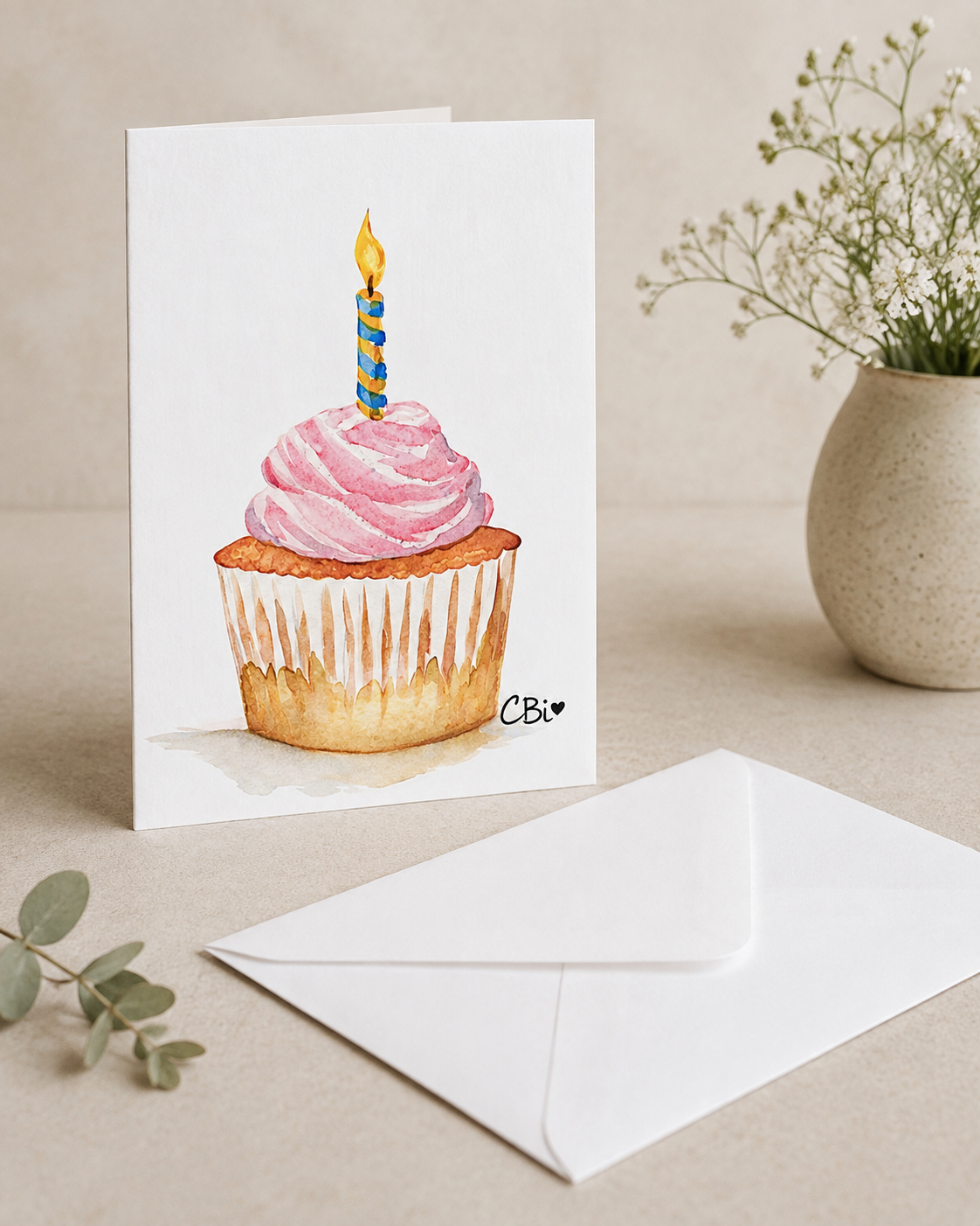 Watercolor birthday cupcake greeting card mockup beside a white envelope