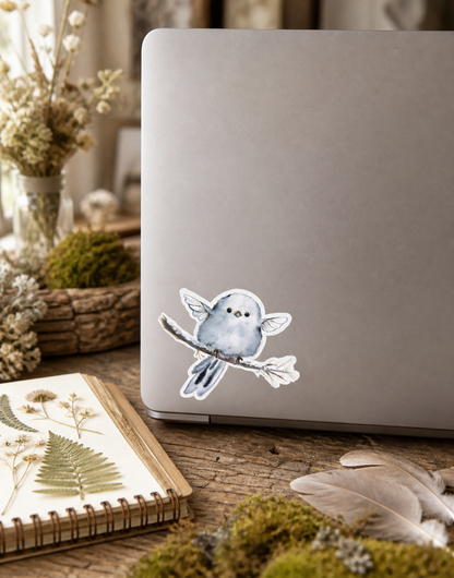 Blue Fairy Nestling vinyl sticker on a laptop in a cottagecore studio
