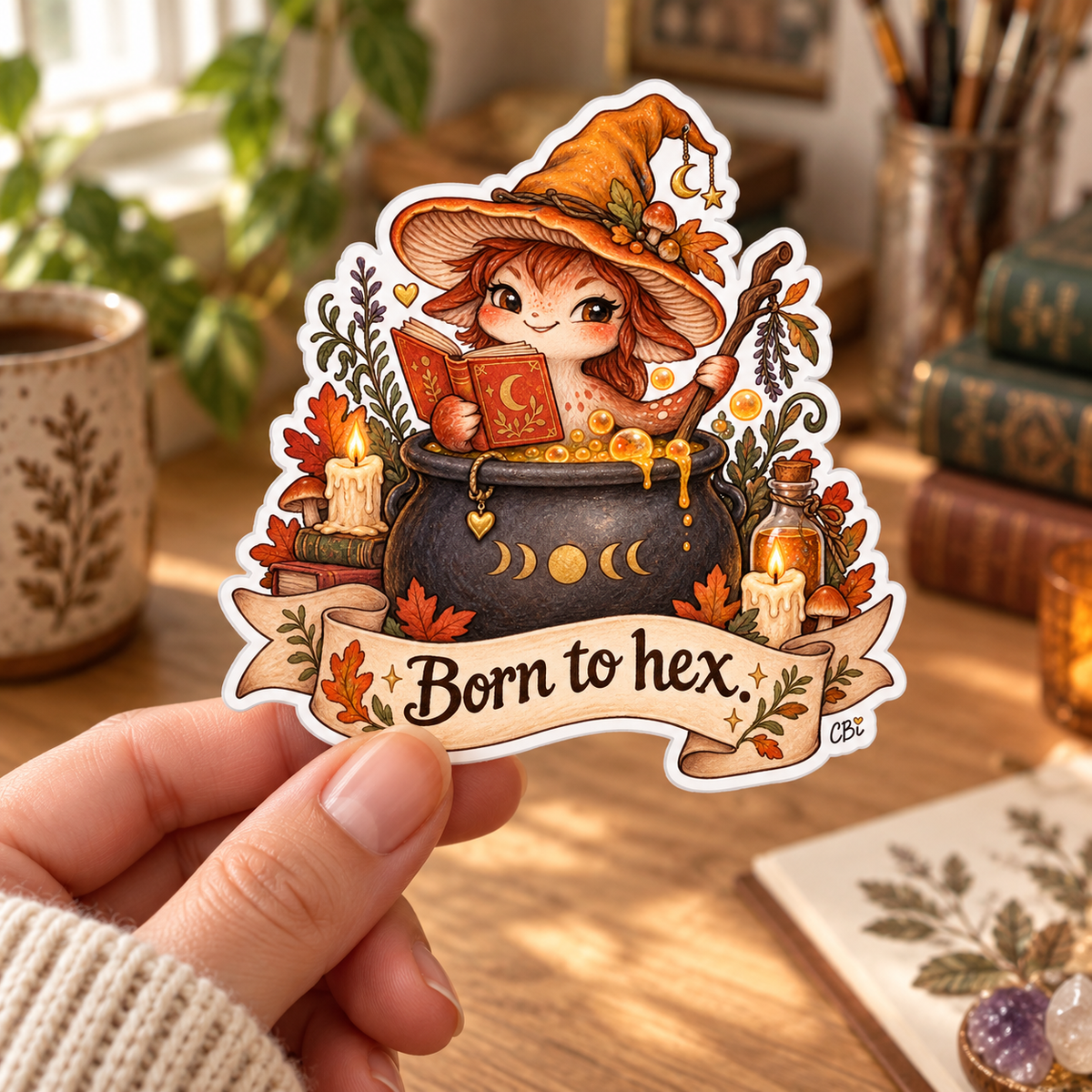 One Born to Hex sticker held in a hand with a cream knit sleeve.