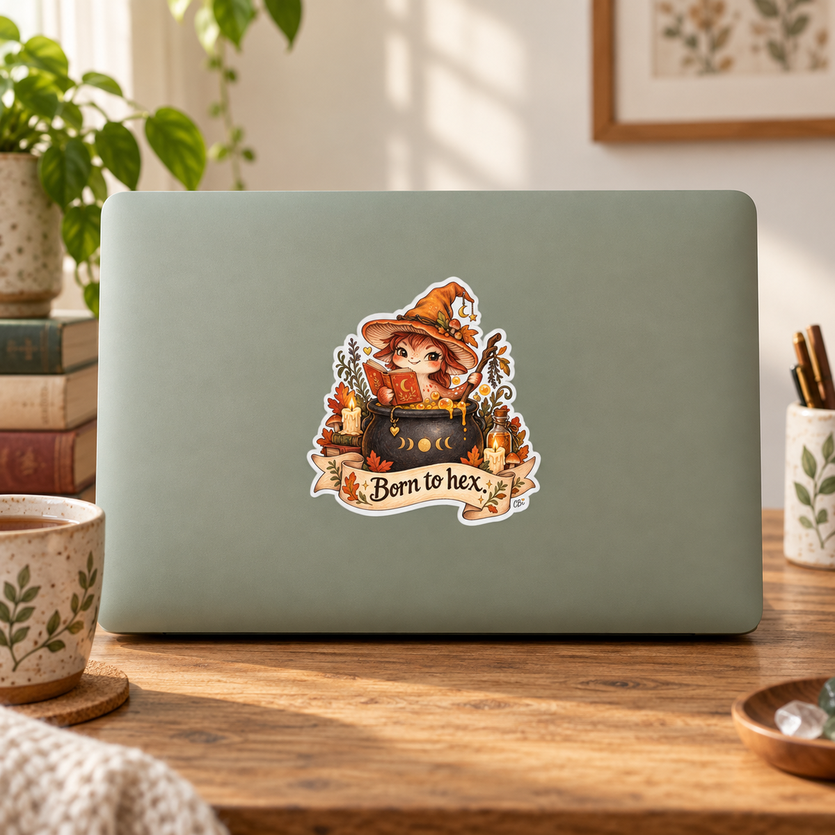 Born to Hex sticker centered on a sage laptop lid.