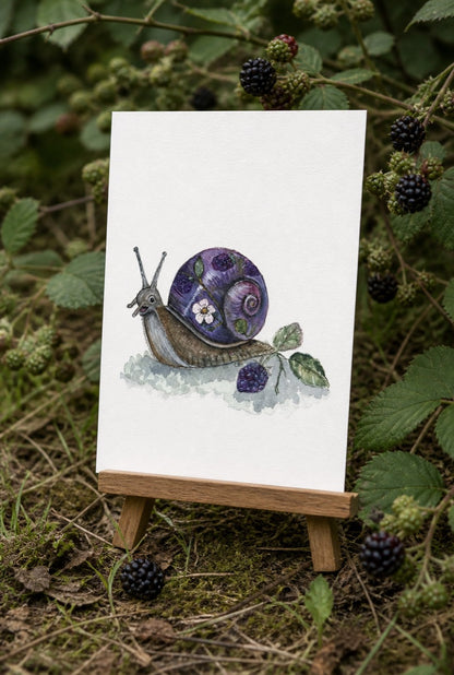 Bramble Snail art print displayed near blackberry bramble and ripe berries