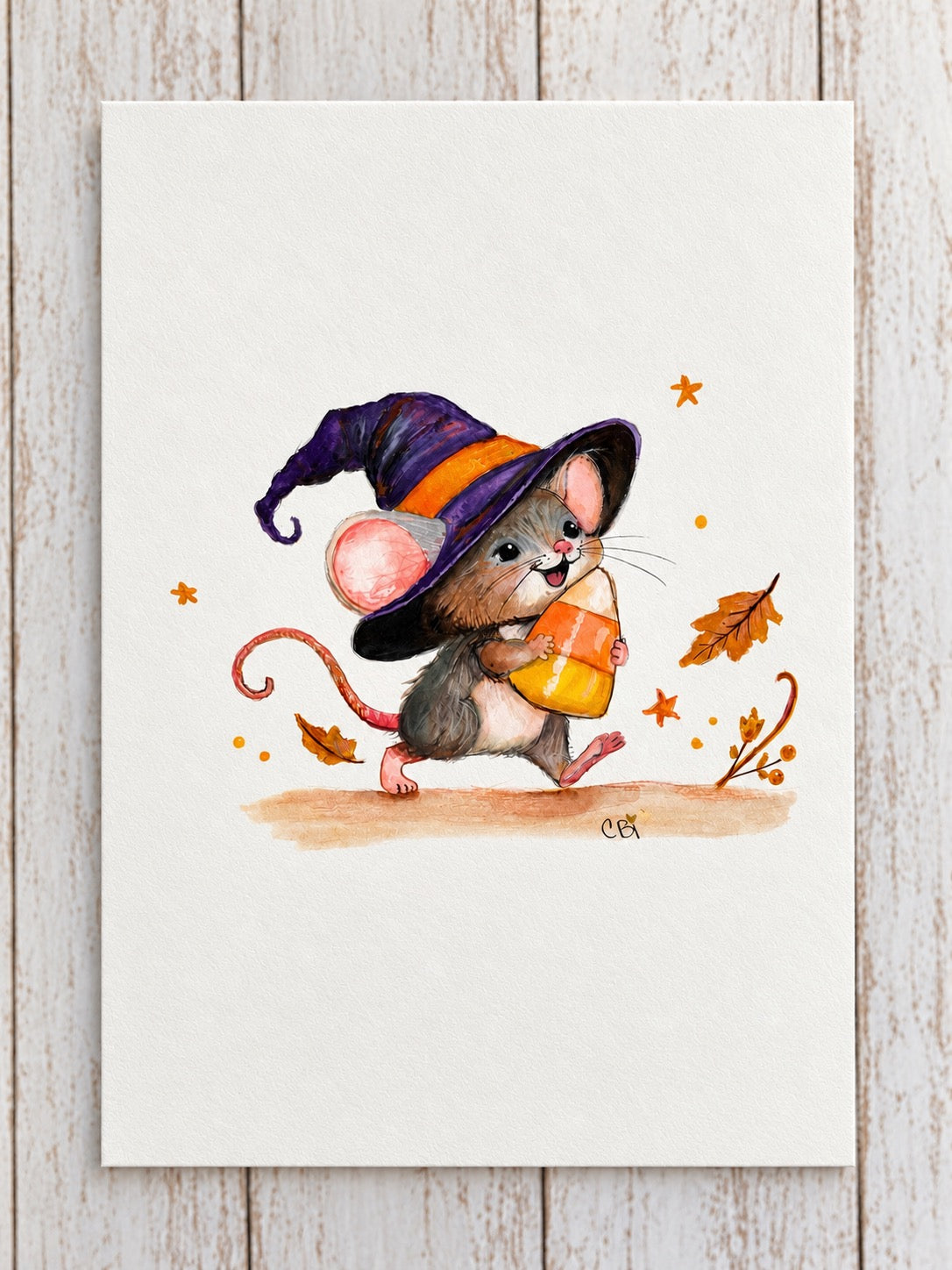 Candy Corn Mischief watercolor painting photographed on pale wood, with hand and backing removed.