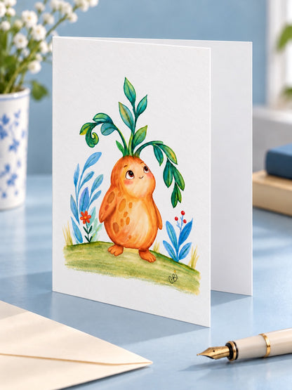 Figment greeting card with artwork inset within white margins and a simple left-side fold, on a blue desk.