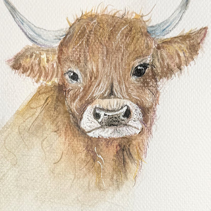 Close-up of the Highland cow’s eyes, shaggy fringe and muzzle, showing watercolor brushwork and paper texture.