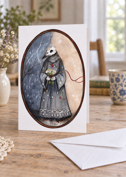 The Keeper Between Seasons greeting card standing slightly open with a left-side fold, full oval artwork on the front, and a separate white envelope.