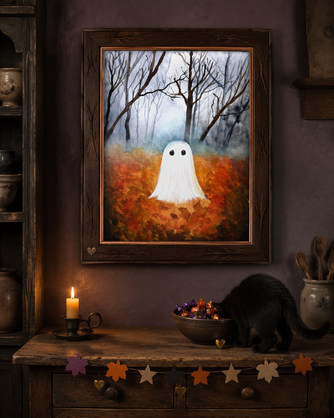 The Little Leaf Ghost print hanging above a cozy autumn sideboard with a black cat, candle, and candy bowl