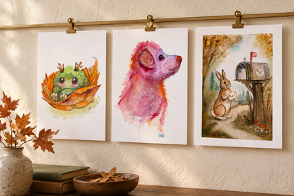 Fall Mossling, Pupkin, and Birch unframed mini prints displayed with brass clips on a cream wall.
