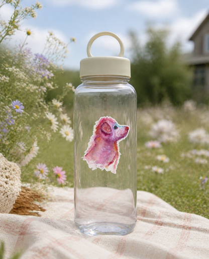 Pupkin vinyl sticker on a clear reusable water bottle in a flower garden
