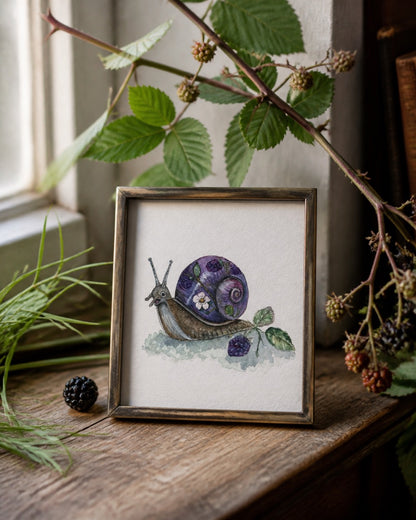 Bramble Snail art print displayed in a cozy reading nook with blackberry and woodland details
